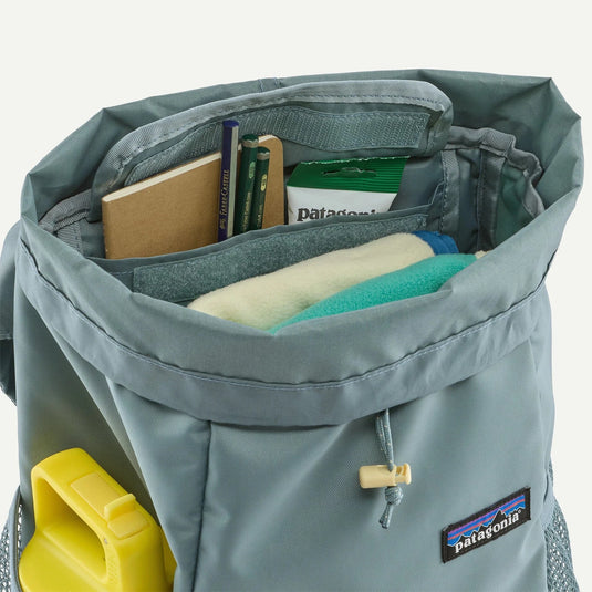 Gray backpack with Patagonia logo open to show items inside on a white background